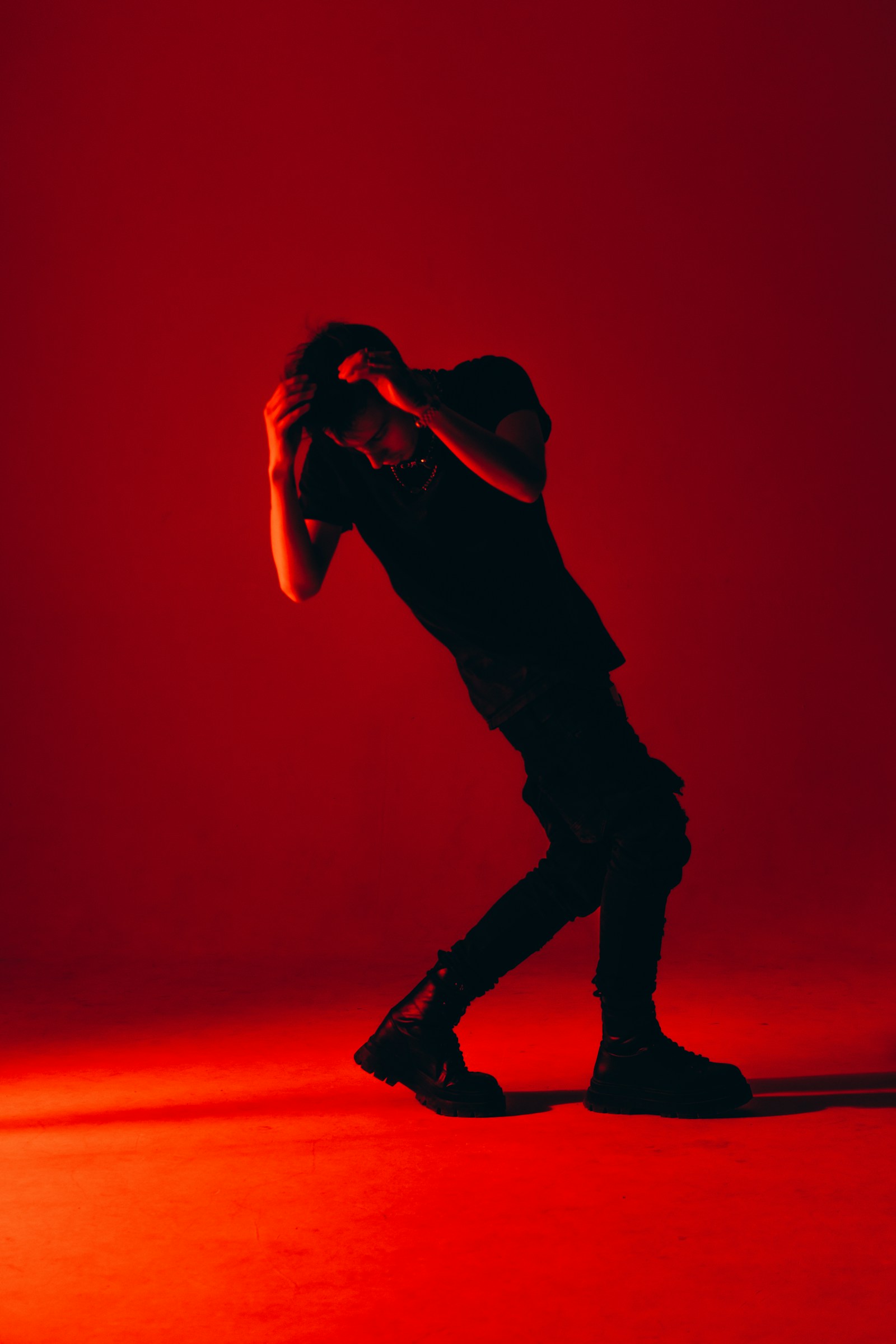 Fashion model standing in a red studio